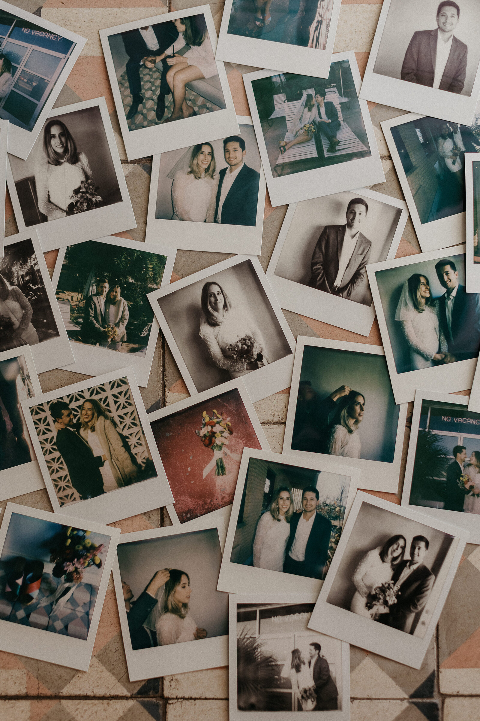 Instant photos of a couple scattered across a pink tiled floor